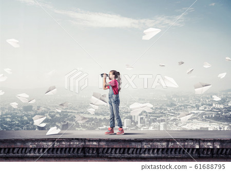 Concept of careless happy childhood with girl of school age look 61688795