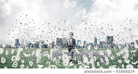 Young businessman or student studying the science and symbols fl Young businessman or student studying the science and symbols fl 61688824