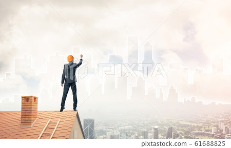 Man architect draw silhouette of modern city on blue sky. Mixed Man architect draw silhouette of modern city on blue sky. Mixed 61688825