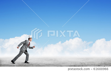 King businessman in elegant suit running and blue sky at background King businessman in elegant suit running and blue sky at background 61688966