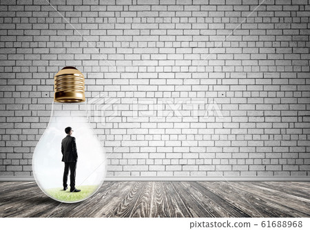 Businessman trapped in bulb Businessman trapped in bulb 61688968
