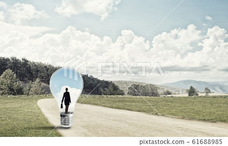 Businesswoman inside light bulb Businesswoman inside light bulb 61688985