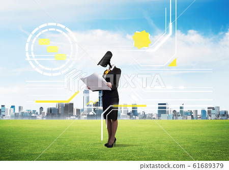 Camera headed woman standing on green grass against modern cityscape Camera headed woman standing on green grass against modern cityscape 61689379