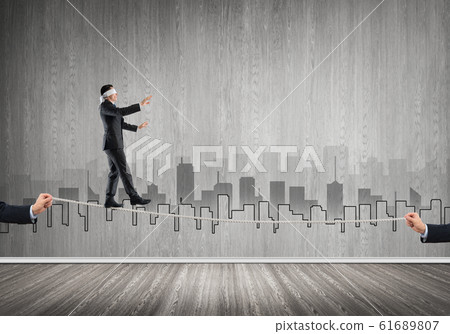 Business concept of risk support and assistance with man balancing on rope 61689807
