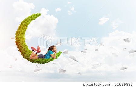 Concept of careless happy childhood with girl dreaming about something 61689882