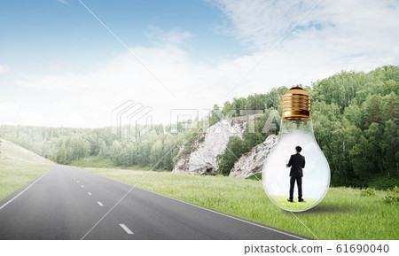 Businessman inside light bulb Businessman inside light bulb 61690040