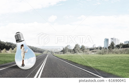 Businesswoman inside light bulb 61690041