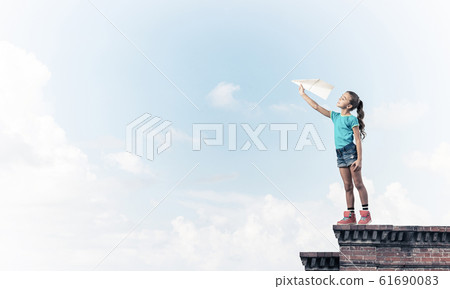 Concept of careless happy childhood with girl dreaming to become Concept of careless happy childhood with girl dreaming to become 61690083