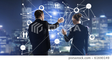 Concept of social connection and networking against night city view and partners working in cooperation Concept of social connection and networking against night city view and partners working in cooperation 61690149