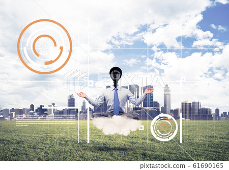 Camera headed man sitting in lotus pose on cloud against modern Camera headed man sitting in lotus pose on cloud against modern 61690165