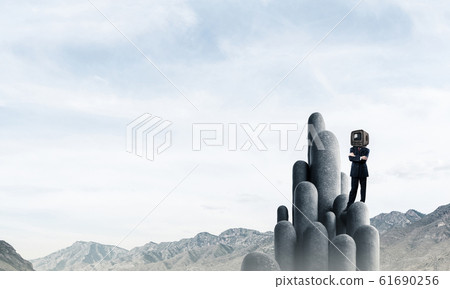 Businessman with an old TV instead of head. 61690256
