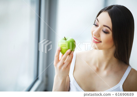 Woman With Apple. Beautiful Girl With White Smile, Healthy Teeth. High Resolution Image 61690689