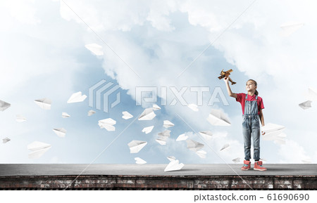 Concept of careless happy childhood with girl dreaming to become Concept of careless happy childhood with girl dreaming to become 61690690