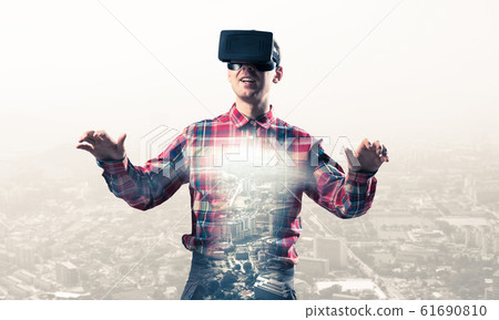 Guy wearing checked shirt and virtual mask stretching hands and Guy wearing checked shirt and virtual mask stretching hands and 61690810