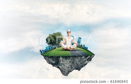 Young woman keeping mind conscious. Young woman keeping mind conscious. 61690843