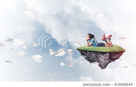 Concept of careless happy childhood with girl dreaming about som 61690844