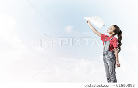 Concept of careless happy childhood with girl dreaming to become Concept of careless happy childhood with girl dreaming to become 61690898