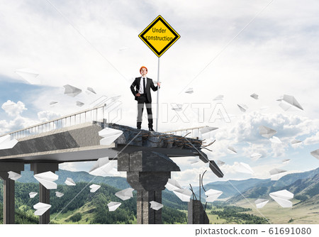 Confident engineer holding street safety sign. Confident engineer holding street safety sign. 61691080