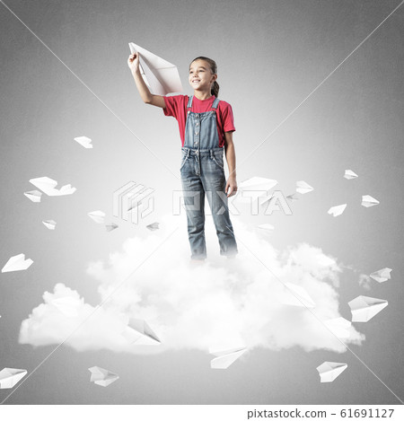 Concept of careless happy childhood with girl dreaming to become 61691127