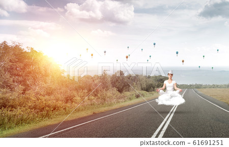 Young woman keeping mind conscious. Young woman keeping mind conscious. 61691251