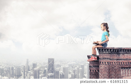 Concept of careless happy childhood with girl exploring this wor Concept of careless happy childhood with girl exploring this wor 61691315