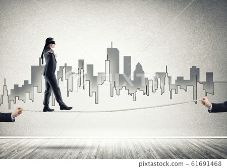 Business concept of risk support and assistance with man balancing on rope Business concept of risk support and assistance with man balancing on rope 61691468