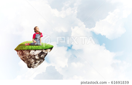 Concept of careless happy childhood with girl dreaming about something 61691839