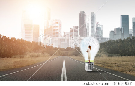 Businesswoman inside light bulb 61691937