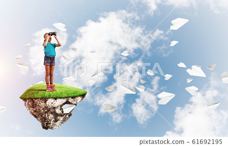 Concept of careless happy childhood with girl looking in binoculars Concept of careless happy childhood with girl looking in binoculars 61692195