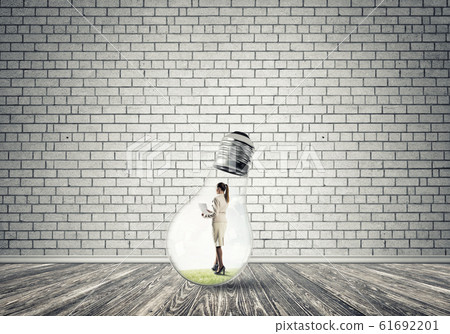 Businesswoman trapped in bulb Businesswoman trapped in bulb 61692201