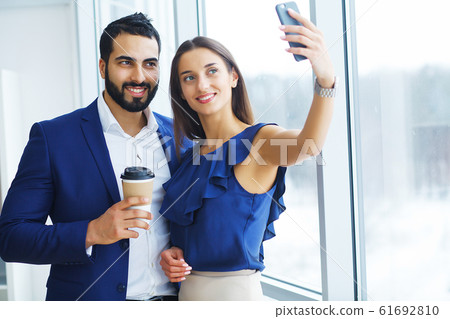Businessman with female colleague or client in office Businessman with female colleague or client in office 61692810