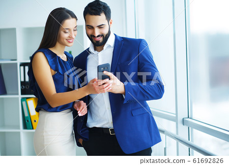 Young colleagues at work in modern office 61692826