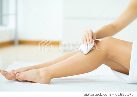 Skin Care. Female leg shaving by electric shaver 61693173