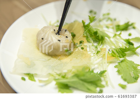 Chopsticks on Xiao Long Pao with vegetable, Chopsticks on Xiao Long Pao with vegetable, 61693387