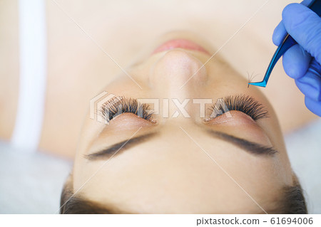 Woman Eye with Long Eyelashes. Eyelash Extension Woman Eye with Long Eyelashes. Eyelash Extension 61694006
