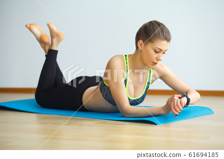 Young yogi attractive woman practicing yoga concept, wearing sportswear, black tank top and pants, full length, white loft background 61694185