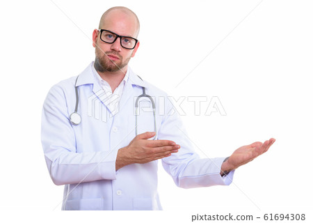 Studio shot of young bald muscular man doctor 61694308