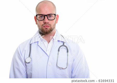 Studio shot of young bald muscular man doctor 61694331