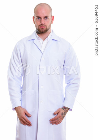 Studio shot of young bald muscular man doctor 61694453