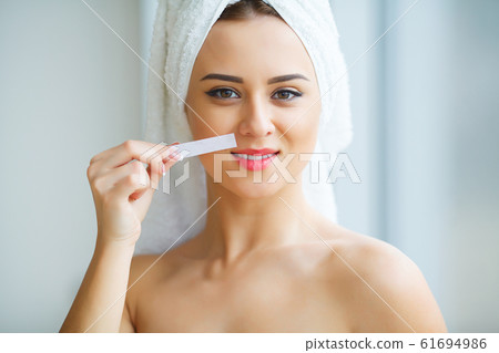 Hair Removal Wax. Young woman reciving facial epilation 61694986