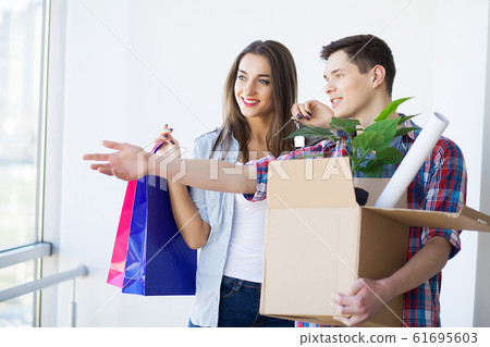 Young family unpacking boxes in a new house. 61695603