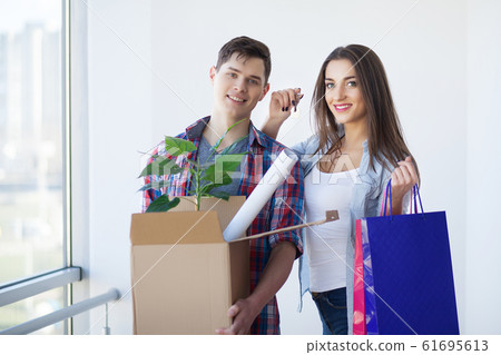Portrait of young couple moving in new home Portrait of young couple moving in new home 61695613