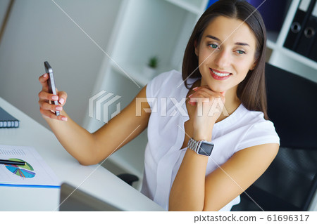 Portrait Of Businesswoman Working In Creative Office Portrait Of Businesswoman Working In Creative Office 61696317