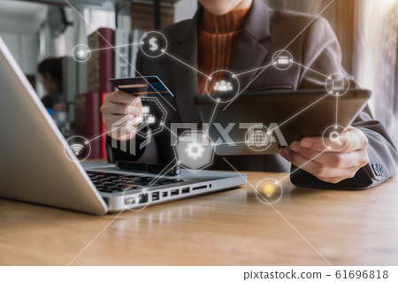 Women using laptop and mobile phone to online shopping and pay by credit card in home office. Women using laptop and mobile phone to online shopping and pay by credit card in home office. 61696818