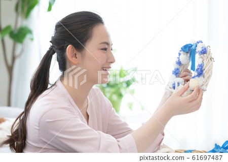 Woman making summer wreath Woman making summer wreath 61697487