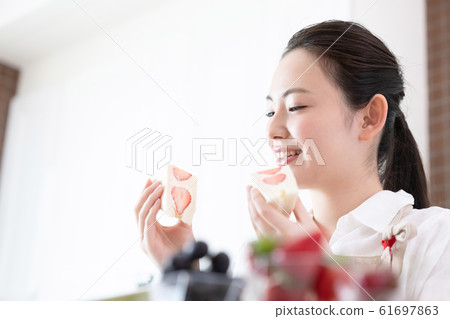 Female fruit sandwich 61697863