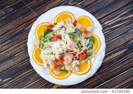 Shrimp in Warm Seafood Salad in a white plate 61700390