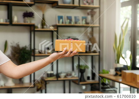 Closeup hands of delivery man holding parcel package  61700810