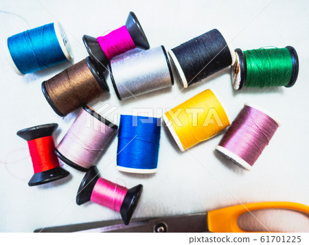 Many colour of thread sewing equipment and scissor on white background Many colour of thread sewing equipment and scissor on white background 61701225