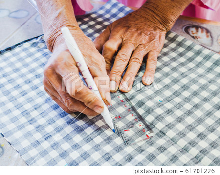 Senior woman hand design with Sewing equipment laptop and smartphone on white background Senior woman hand design with Sewing equipment laptop and smartphone on white background 61701226